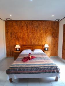 a bedroom with a bed with a red bird on it at Satria Bungalow in Uluwatu +103 photos