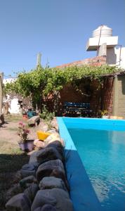 a swimming pool in front of a house at Casa Lago in La Silleta