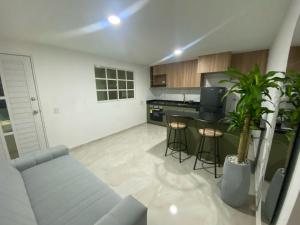 a living room with a couch and a kitchen at Apartamento Sabaii 201 in Cartagena de Indias +5 photos