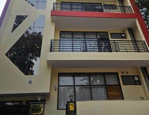 a building with a large letter v on it at Ashirwaad 249 in Greater Noida