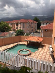a small swimming pool with a white fence at Embassy Royale in Kingston