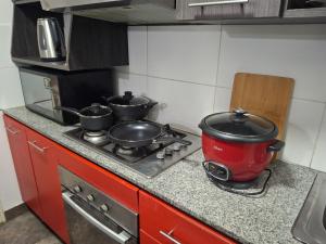 a kitchen with two pots on a stove at Alojamiento Familiar en zona exclusiva de Chiclayo in Chiclayo +7 photos