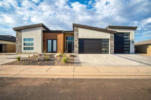 a large house with a driveway at Sandstone Suite Private Room in Shared Home in Hurricane