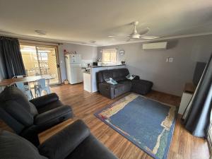 a living room with a couch and a table at Sunny Brae in Emu Bay