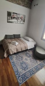 a bedroom with a large bed with a rug and a window at Urban 34 - station & centre in Treviso +31 photos