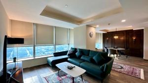 a living room with a couch and a table at Luxury Centaurus Apartments Islamabad in Islamabad