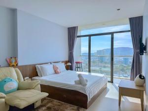 a bedroom with a bed and a chair and a window at Condotel CSJ Vũng Tàu - Apartment Luxury CSJ Vung Tau in Vung Tau +116 photos