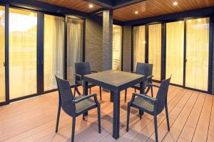熊本市にあるGuest house Watanabeの窓のあるポーチ(黒いテーブルと椅子付)