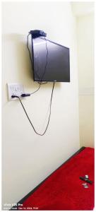 a flat screen tv hanging on a wall at HOTEL PREMIUM PUJA Near Mandirpara JHEEL in Jādabpur