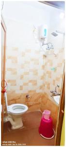 a small bathroom with a toilet and a sink at HOTEL PREMIUM PUJA Near Mandirpara JHEEL in Jādabpur