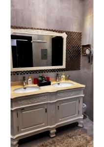 a bathroom with two sinks and a large mirror at abha condo in Abha +58 photos