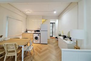 a kitchen and dining room with a table and chairs at Wanglang Home in Bangkok Noi