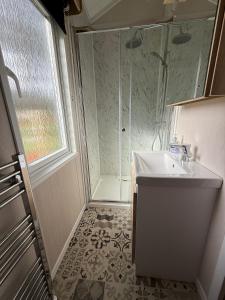 a bathroom with a sink and a shower at The Willy Gunn Pod - Beautiful, luxury pod in Aberlour +14 photos