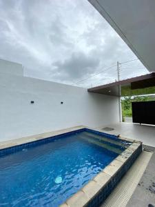 a large blue swimming pool in a building at Villa Kila Rengganis Lombok in Prampuan