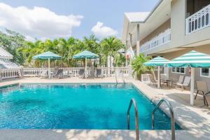 a pool at a resort with chairs and umbrellas at Blue Horizon in Hua Hin