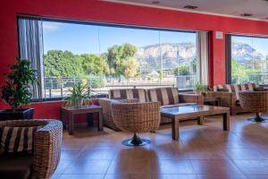a restaurant with chairs and tables and a large window at Nou Avenida in Gata de Gorgos
