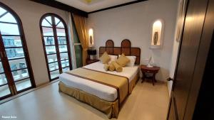 a bedroom with a bed with a teddy bear on it at Poseidon Boutique Hotel in Pattaya South +30 photos