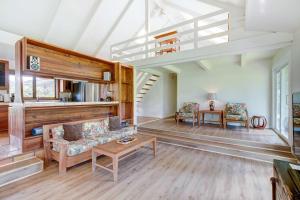 a living room with a couch and a table at Hale Kamalani Mountain Villa and Golf Course Views in Princeville