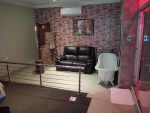a living room with a couch and a toilet at Steps On Cape Guest House in Gqeberha
