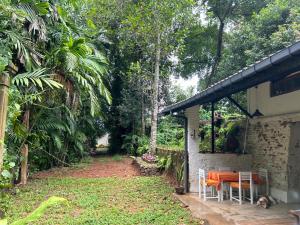 a house with a table and chairs in a yard at Wilwatte Retreat in Mirigama