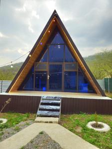 a house with a triangular roof with a staircase at Xalxal Luxe Lodge in Oghuz +14 photos