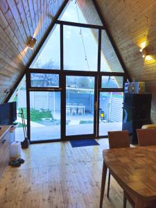 a room with a large window with a table and chairs at Xalxal Luxe Lodge in Oghuz