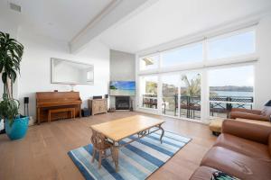 a living room with a table and a piano at Water Views on Every Floor for this multi Holiday Home - Walk to the Beach in Carlsbad