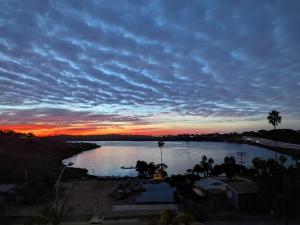 a sunset over a large body of water at Water Views on Every Floor for this multi Holiday Home - Walk to the Beach in Carlsbad +45 photos