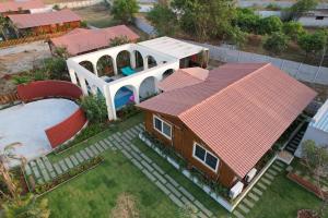 an aerial view of a house with a swimming pool at Anagha, Wooden Cabin with Private Pool in Hyderabad
