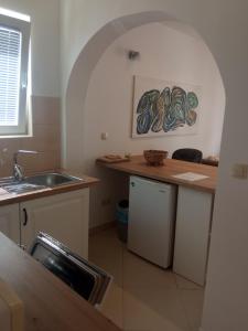 a kitchen with a sink and a counter top at Apartments Tomić in Vodice +129 photos