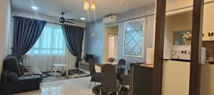a living room with a table and a dining room at Leezahomestay in Bayan Lepas