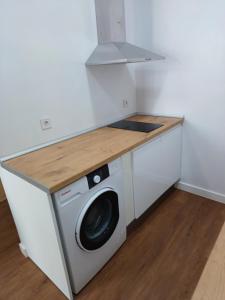 a washer and dryer in a kitchen with a counter at Dulcinea in Seville +17 photos