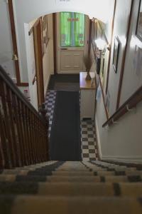 a hallway with stairs and a door in a building at The Eastleigh in Skegness