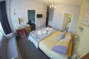 a bedroom with a bed and a sink in it at The Eastleigh in Skegness