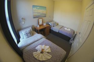 a hotel room with two beds with a bow on them at The Eastleigh in Skegness
