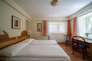 Postel nebo postele na pokoji v ubytování Easy Stay by Hotel La Perla + 37 fotografií