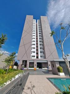 a large white building with a pool in front of it at V'saf Homestay Alor Setar in Alor Setar