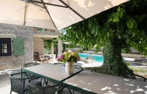 a table and chairs with a vase of flowers on it at Villa Stanza in Rovinj