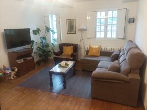 a living room with a couch and a coffee table at Casa do Cuco, Ribeira Sacra in Ourense