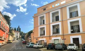 a building with cars parked on the side of a street at Casa vacanza Donna Rosalia in Gaeta