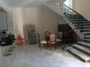 a living room with a staircase and a table and chairs at Villa Ahmed Youssef in King Mariout