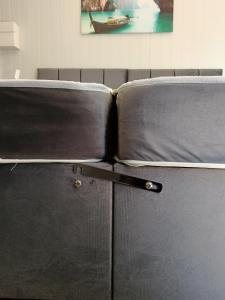 a close up of a couch with a handle at Peaceful 2-bedrooms guesthouse, Sleep 4, Parking, Private entrance, Heating, AirCon, SuperFast Wifi in Derby