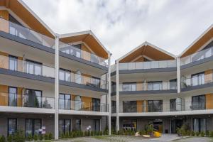 an image of an apartment building with balconies at Trevilles Apartamenty - Słoneczny Stok in Szklarska Poręba