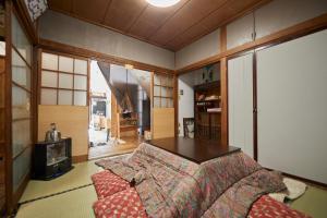 a bedroom with a bed and a table in it at KARASUYA GuestHouse in Takasaki