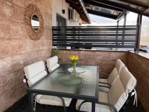 a black table and white chairs on a balcony at Dionis in Veliko Gradište
