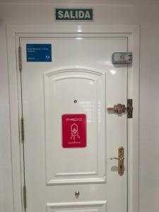 a white door with a sign on it at Costa Marina III - 1ª línea de playa in El Borseral