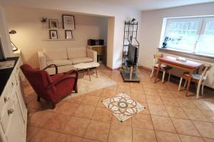 a living room with a couch and a table at Beautiful apartment for a Lüneburg getaway in Lüneburg +7 photos