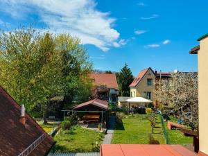 a view of a backyard of a house with a yard at Ferienhaus - gemütlich und traditionell auf 90 m2 in Fürstenfeld