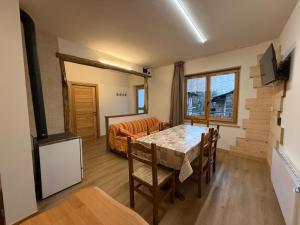 a living room with a dining room table and a couch at La Ca d'Marietta in Paesana
