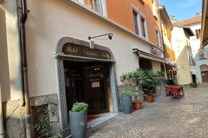 a building with a sign over the entrance to a restaurant at Hotel Saini with Air conditioning in Stresa